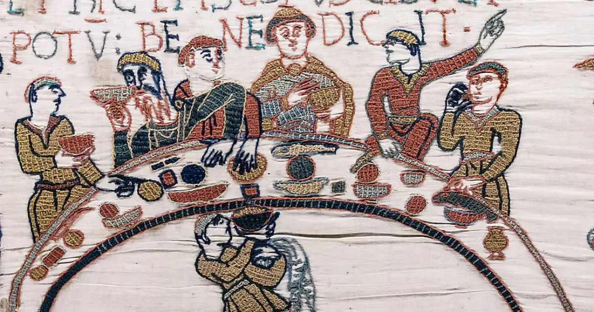 Bayeux Tapestry - Scene 43: Bishop Odo blesses the first banquet that Duke William and the Norman Barons hold on English soil. / Wikimedia Commons Bayeux Tapestry Scene43 Banquet Odo